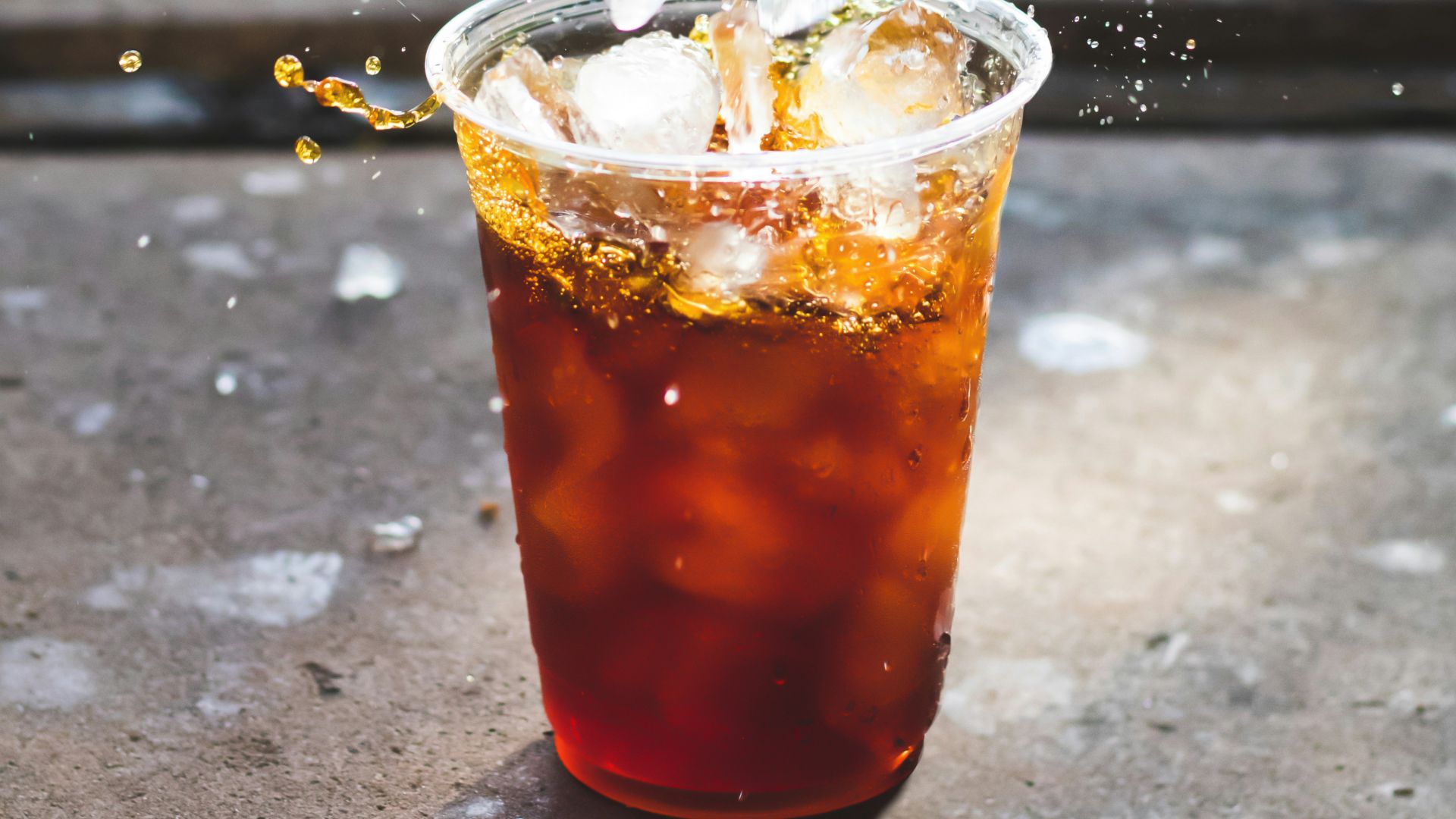 macro photography of dropping ice cube in cup