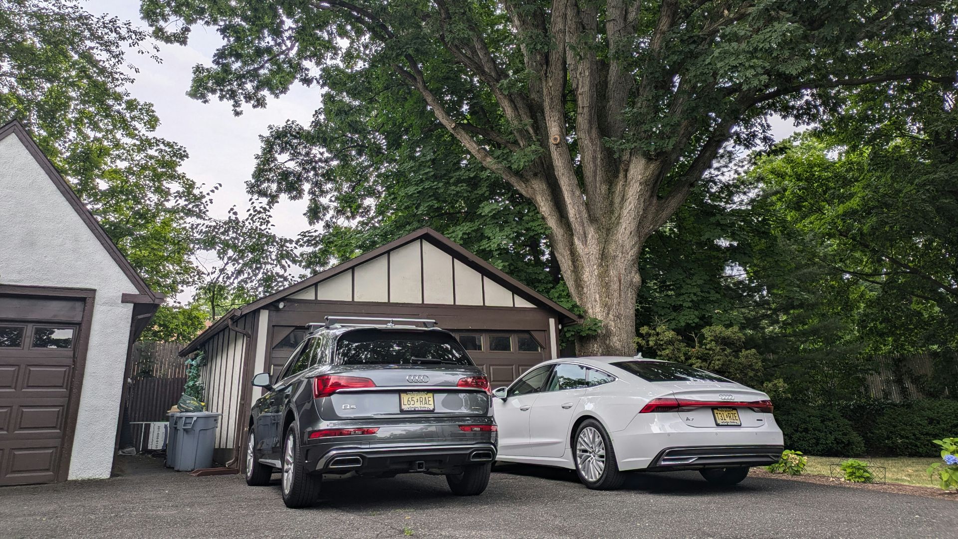 Two cars parked in front of a garage