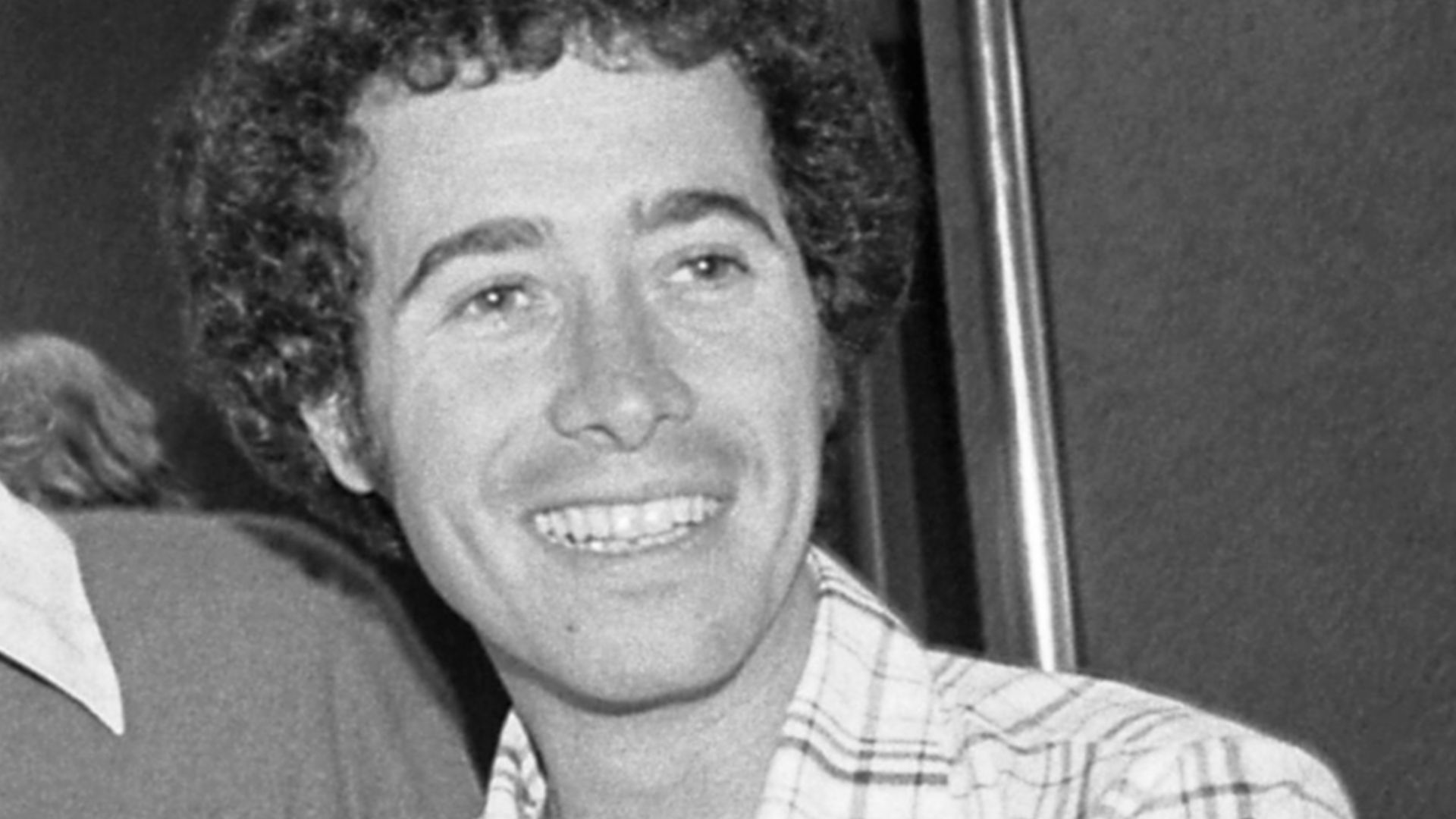 David Geffen standing under the Roxy nightclub marquee in Los Angeles