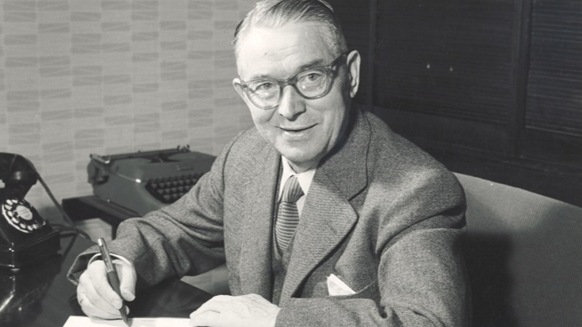 Ole Kirk Christiansen photographed at his desk in 1957