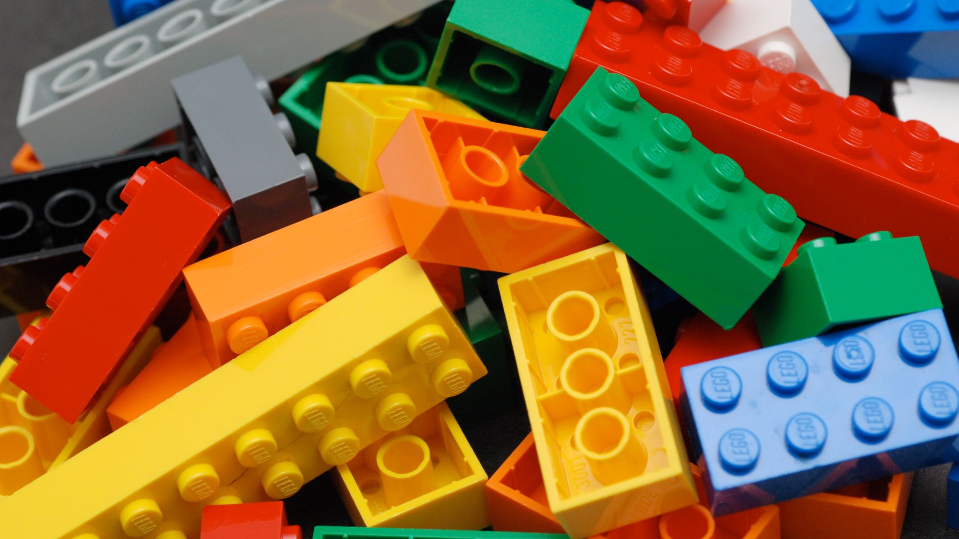 A pile of Lego blocks, of assorted colors and sizes.