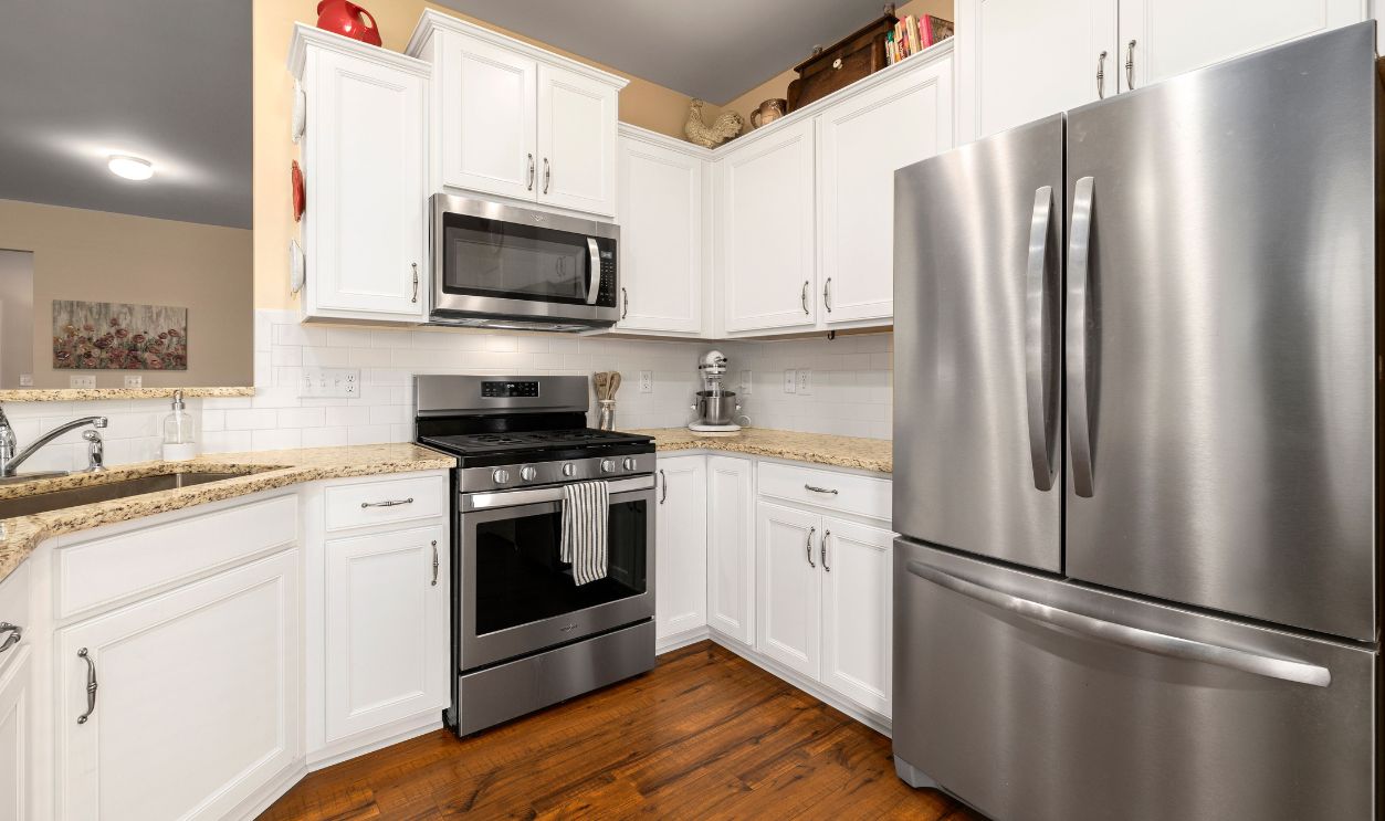 Sleek modern kitchen featuring stainless steel appliances and white cabinets