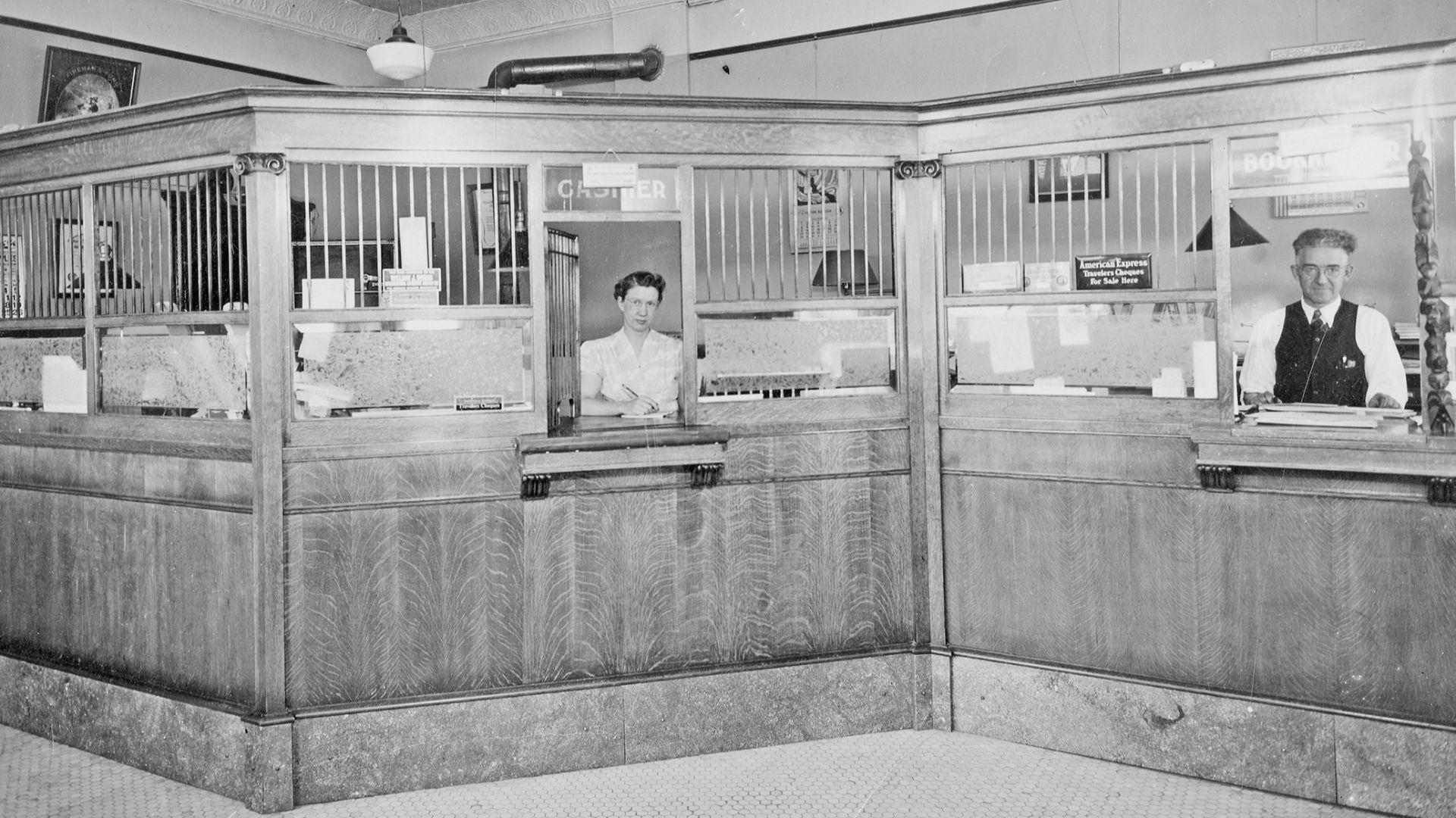 Interior of the Farmington State Bank on the southwest corner of 1st and Main Streets. Note: names are listed left to right as subjects appear. Names: _; Hayfield, Claude.