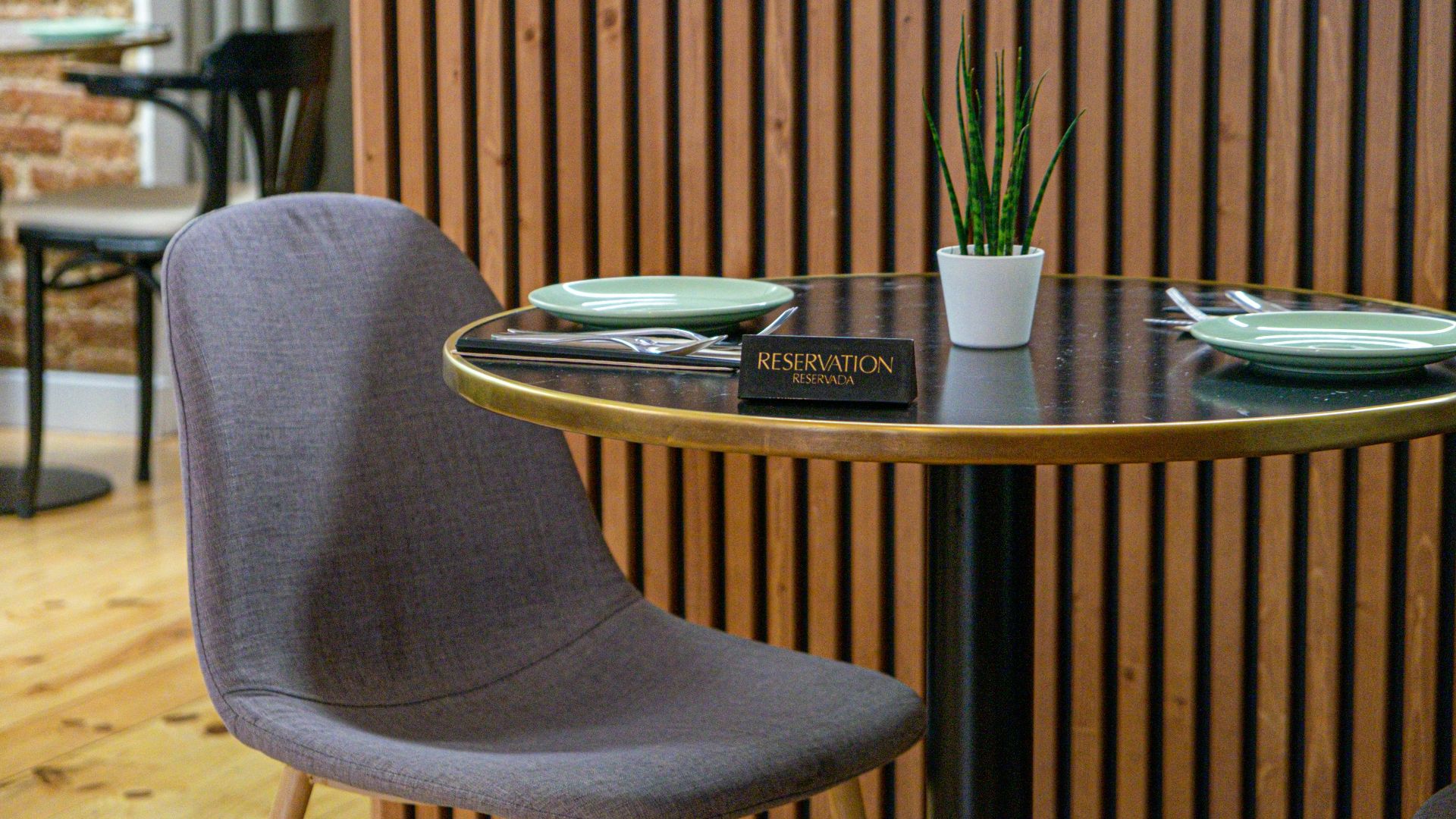 a table with two chairs and a potted plant