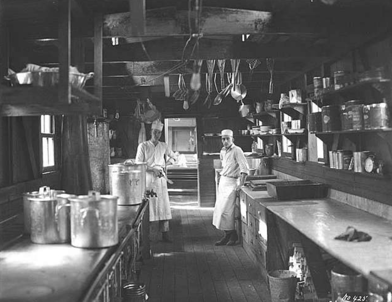 People  posing for a photo in a kitchen