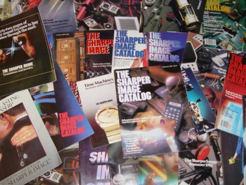 pile of Sharper image Catalogs
