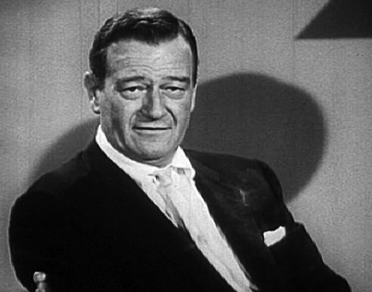 John Wayne wearing a suit