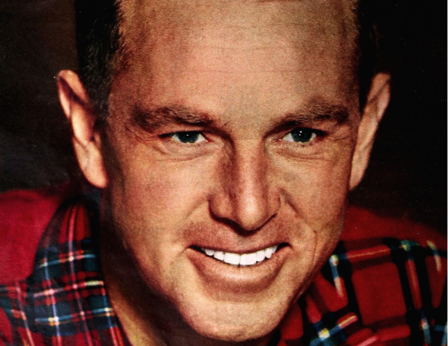 Sterling Hayden wearing a shirt and smiling at the camera
