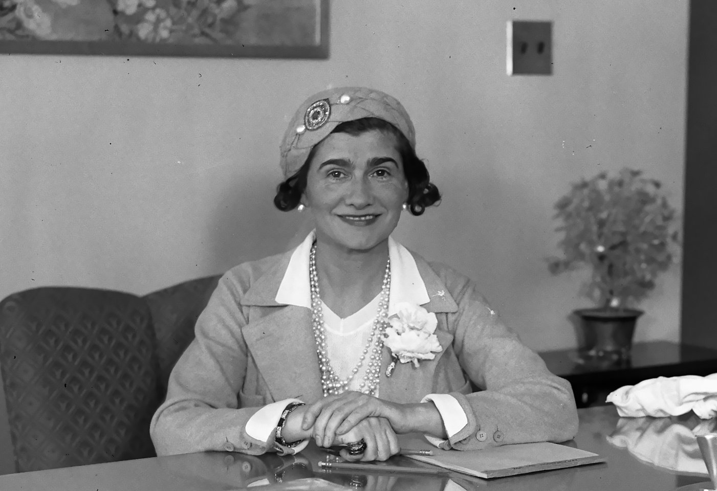 Coco Chanel sitting on a desk