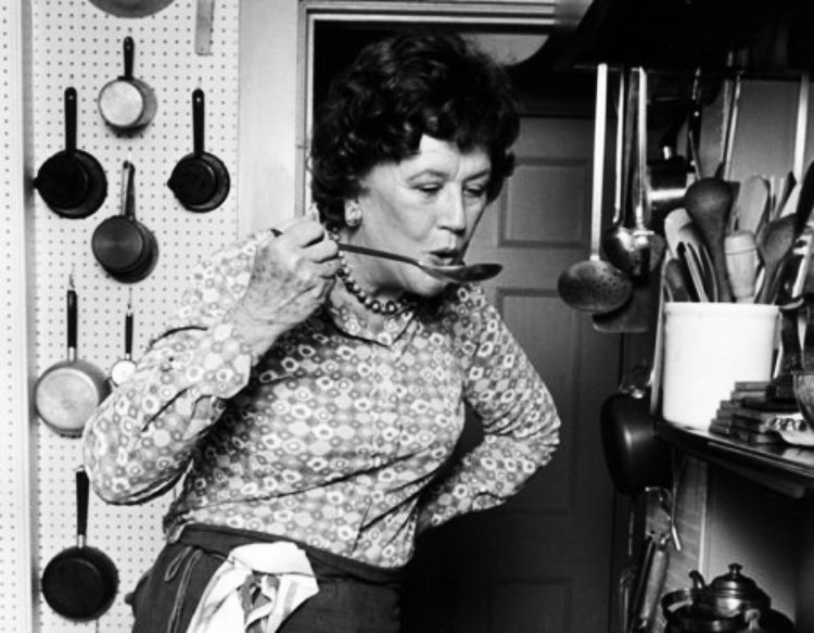 Julia Child in her kitchen cooking