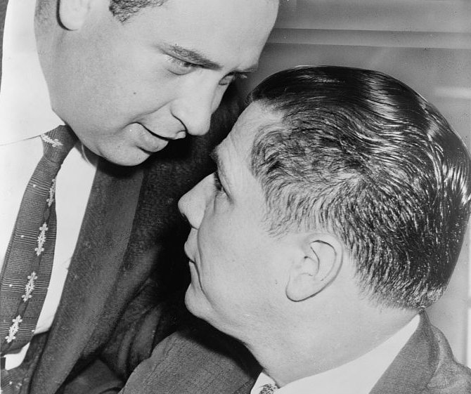 Bernard Spindel (d. 1972) whispers in ear of James R. Hoffa (b. 1913)