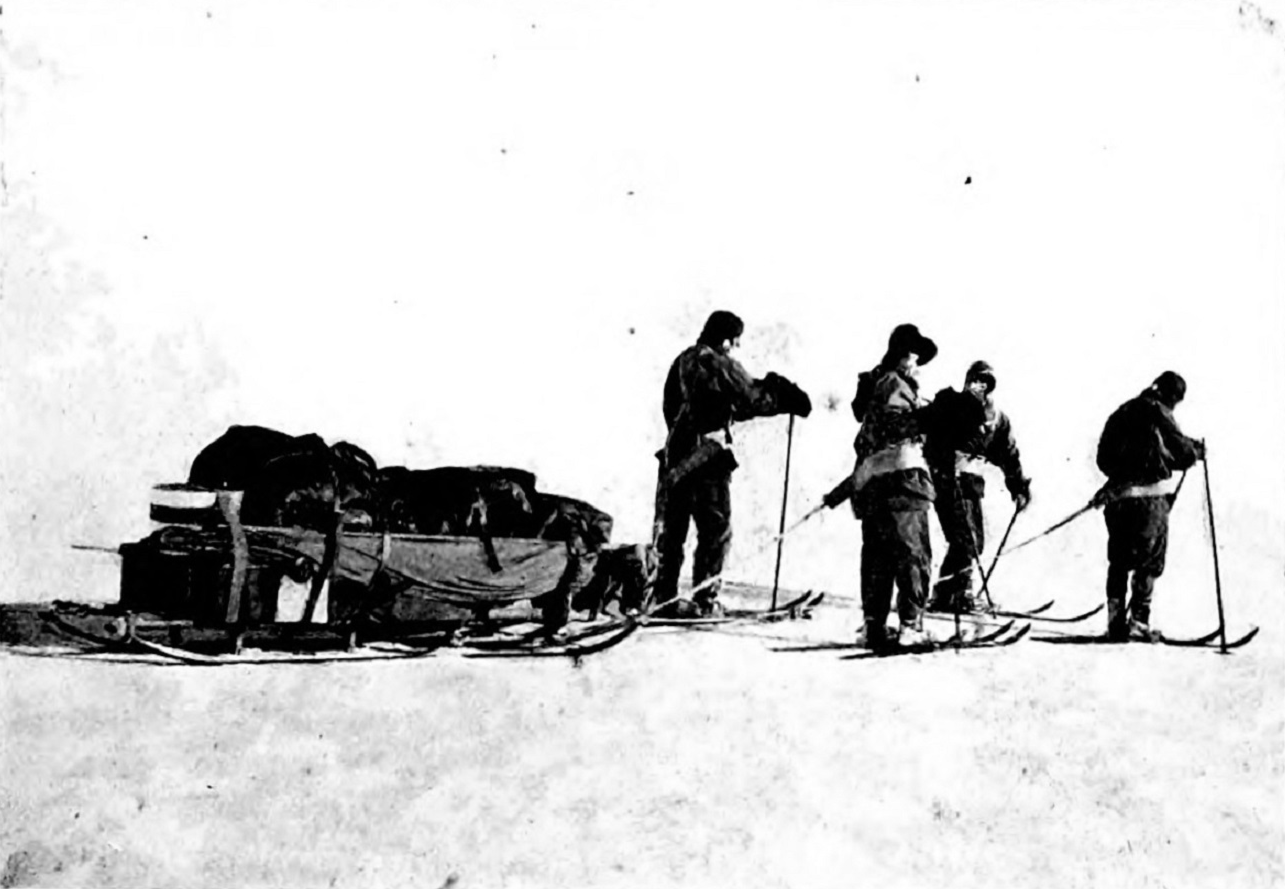 A squad mounted on skis pulling a sled. - 1914