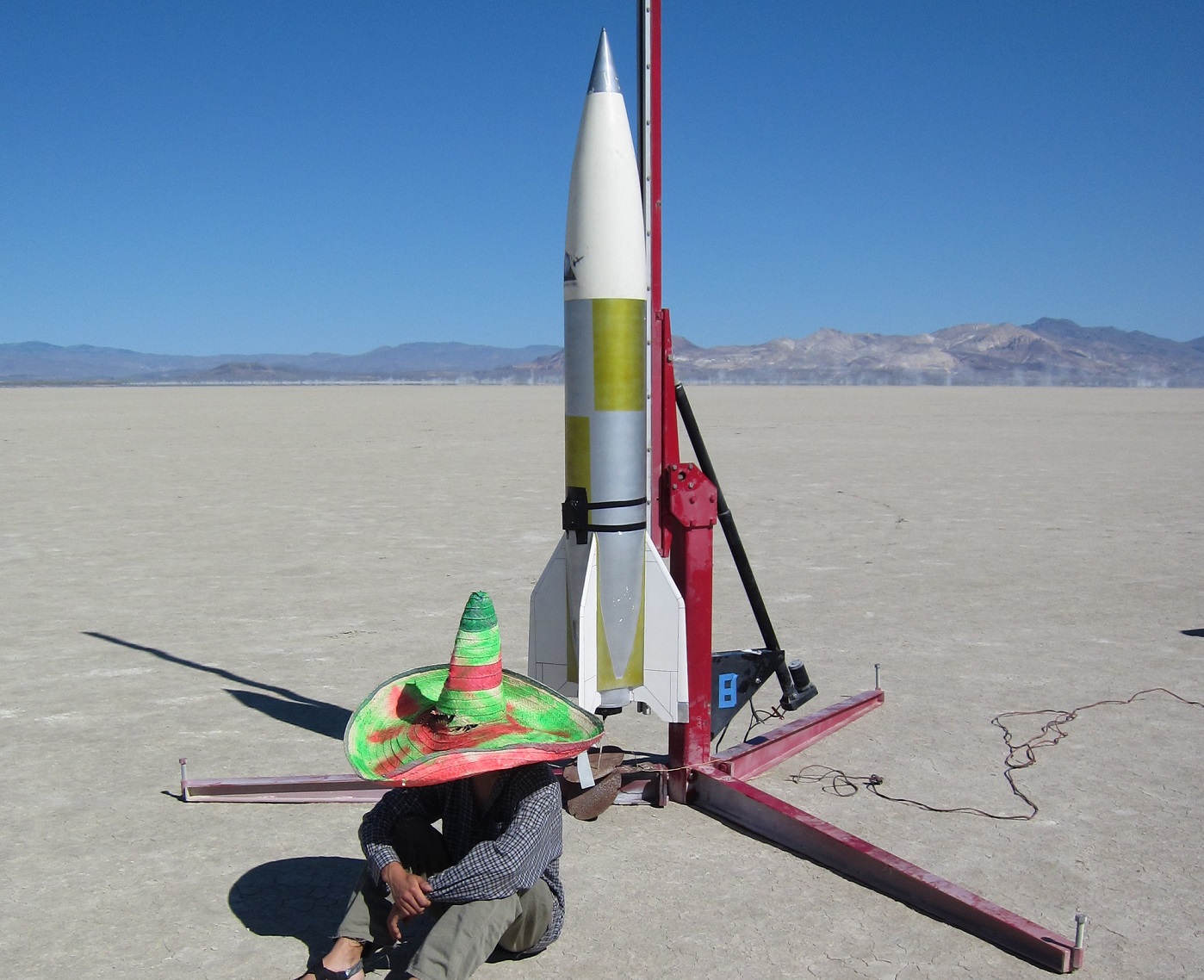 Man seating near rocket.