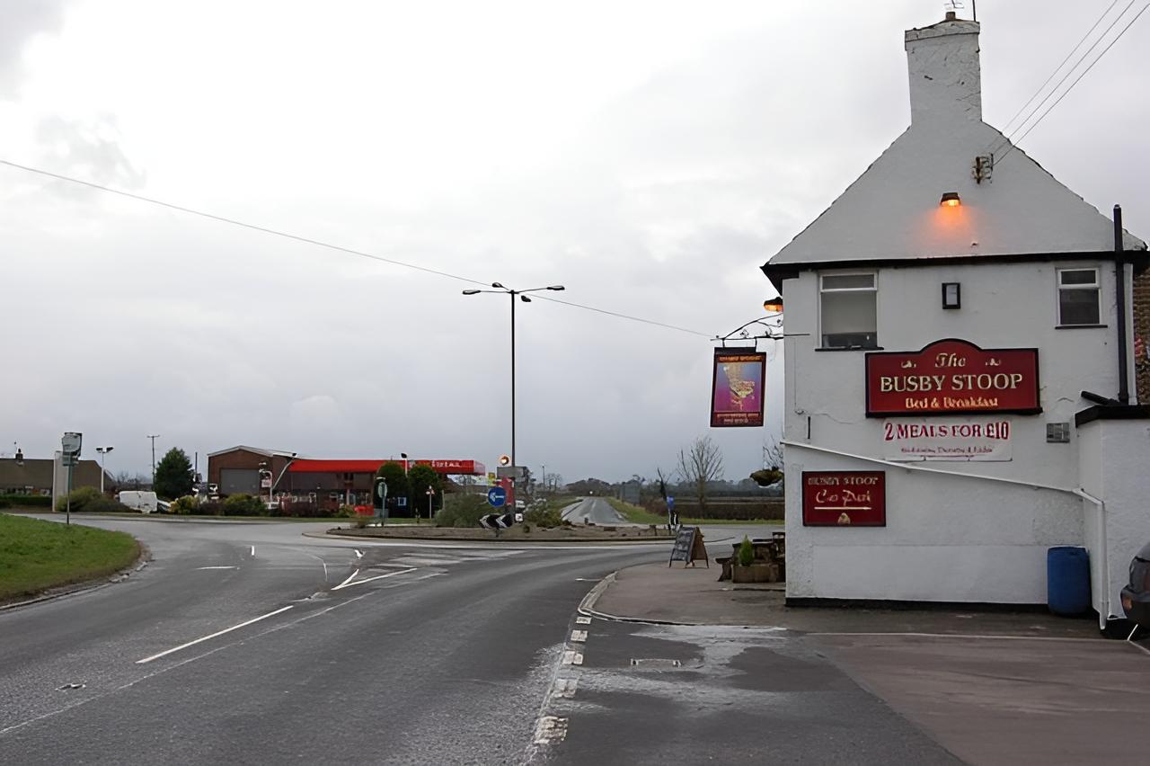 Busby Stoop Inn and garage, cloudy sky in background.