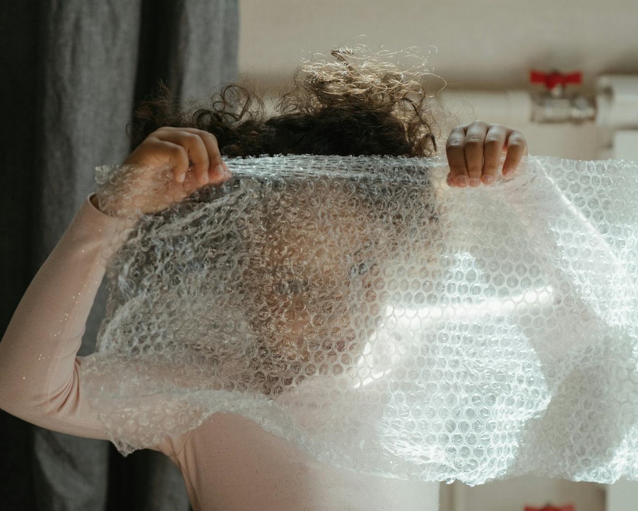 Kid holding a bubble wrap.