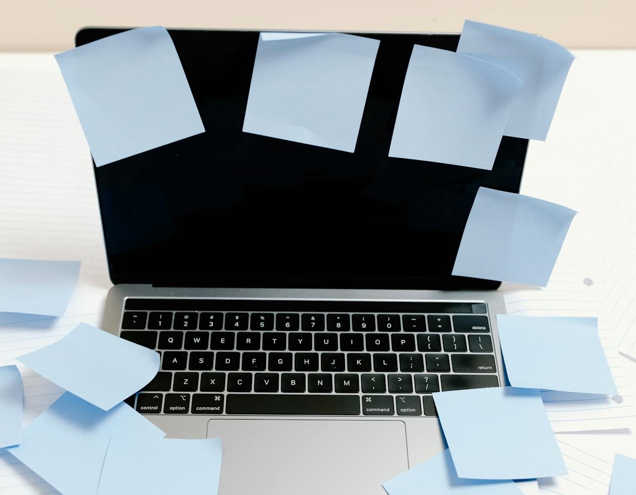 Black and Silver Laptop with Blue Sticky Notes