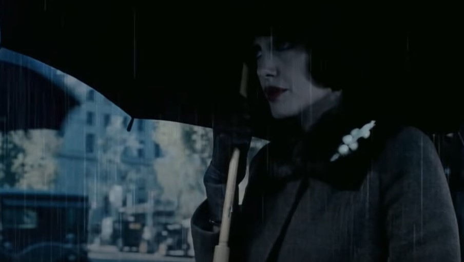 Angelina Jolie in coat wearing umbrella