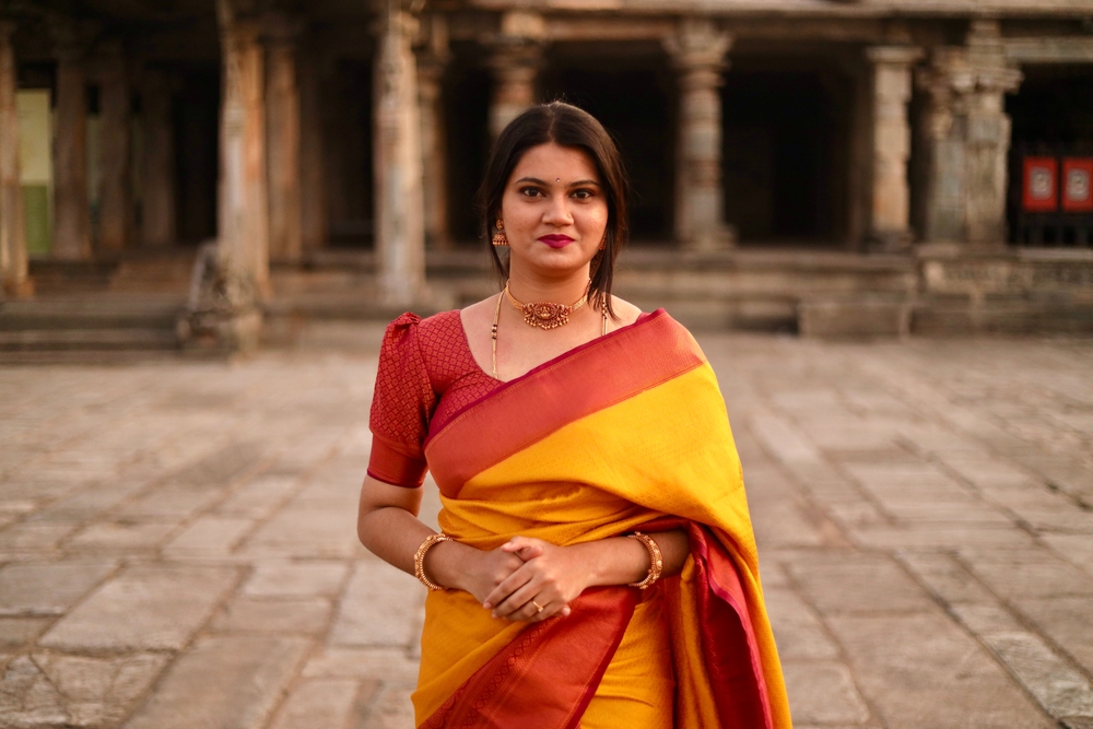 young Indian woman in  yellow and red coloured saree