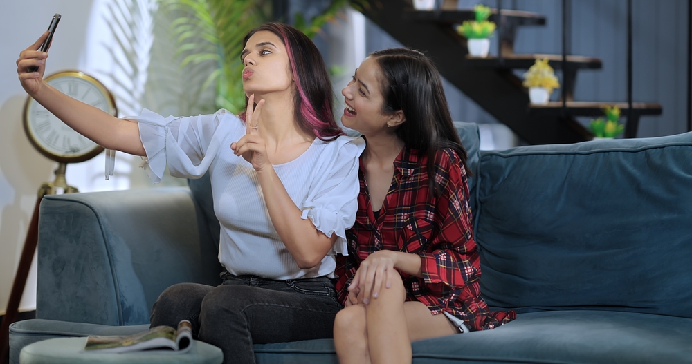image of two girls taking selfie