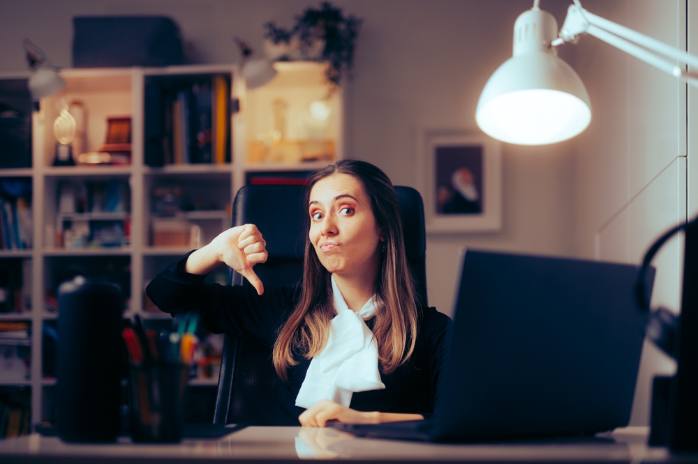 Woman Working at her Desk Giving Negative Feedback