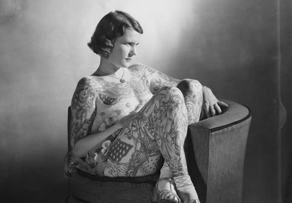 Tattooed lady Betty Broadbent sitting on an armchair