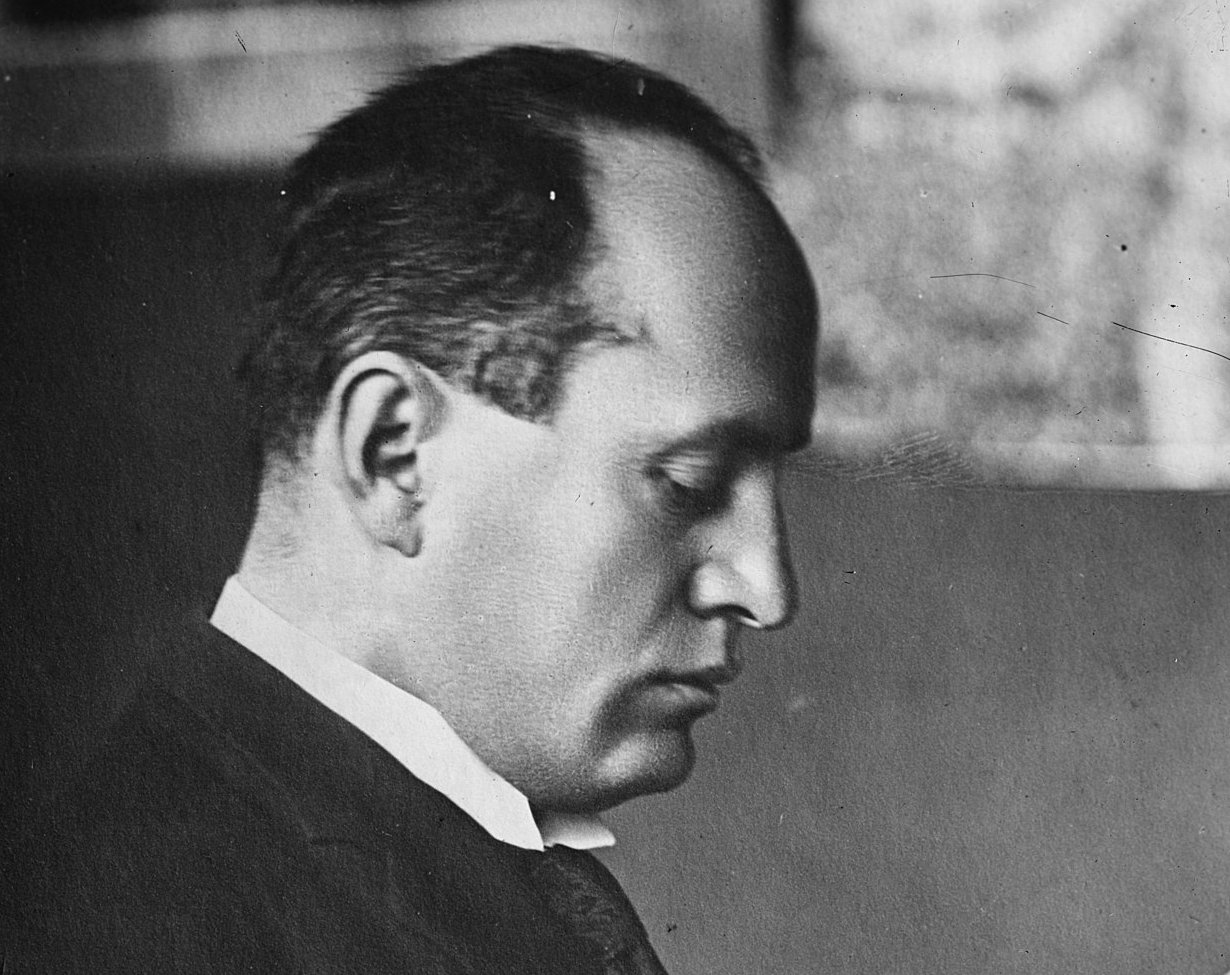 Grayscale Portrait Photo of Benito Mussolini in dark outfit