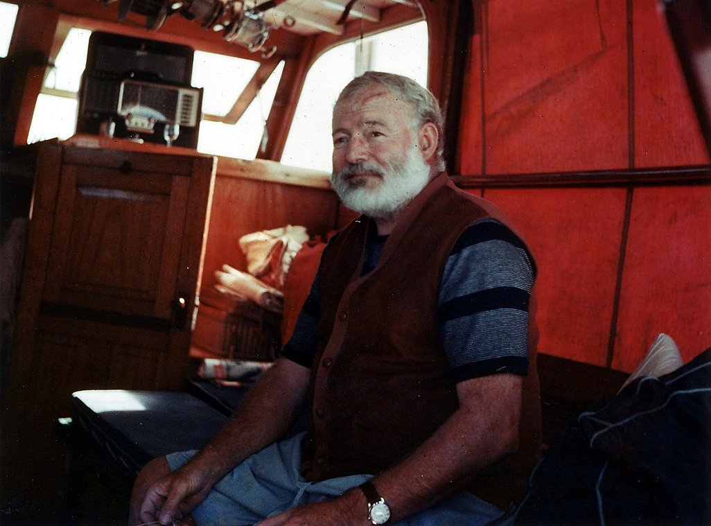 Portrait Photo of Ernest Hemingway in the cabin of his boat 