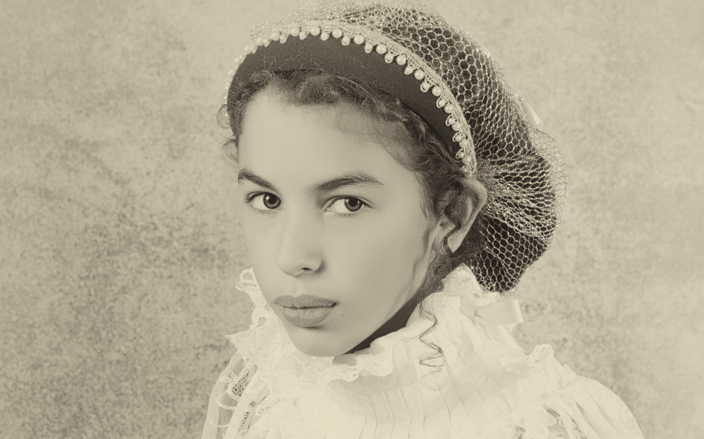 Sweet victorian girl posing in the old style