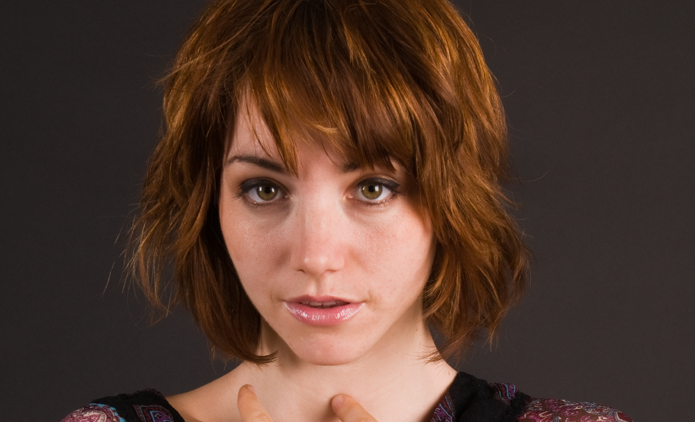 Pretty young brunette in a sheer print blouse