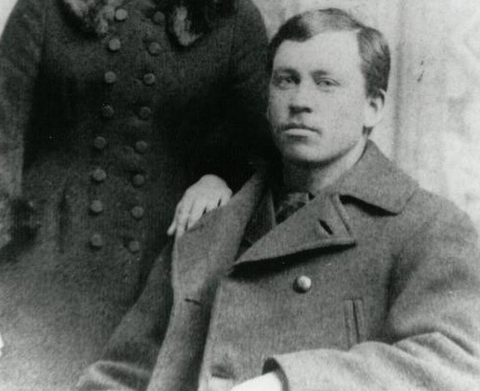 Grayscale Portrait Photo of Almanzo Wilder in a gray coat
