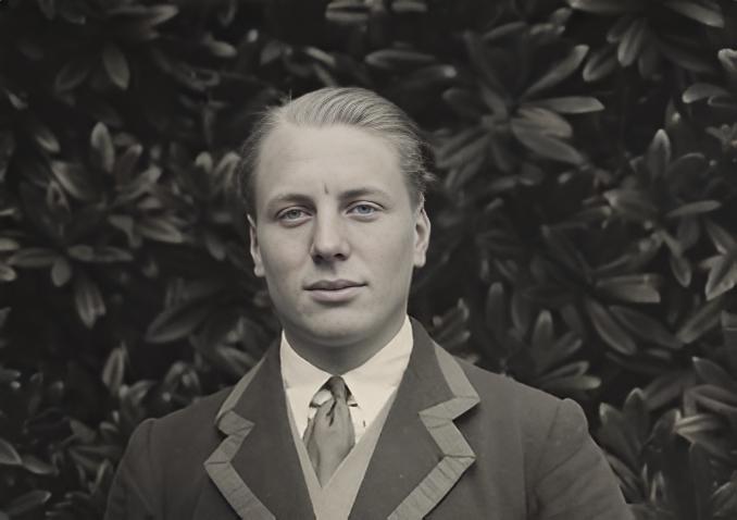 Grayscale Portrait Photo of Andrew Irvine in a gray suit