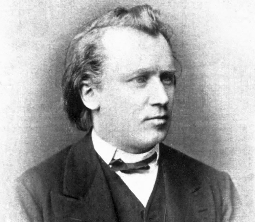 Grayscale Portrait Photo of Johannes Brahms in a dark suit