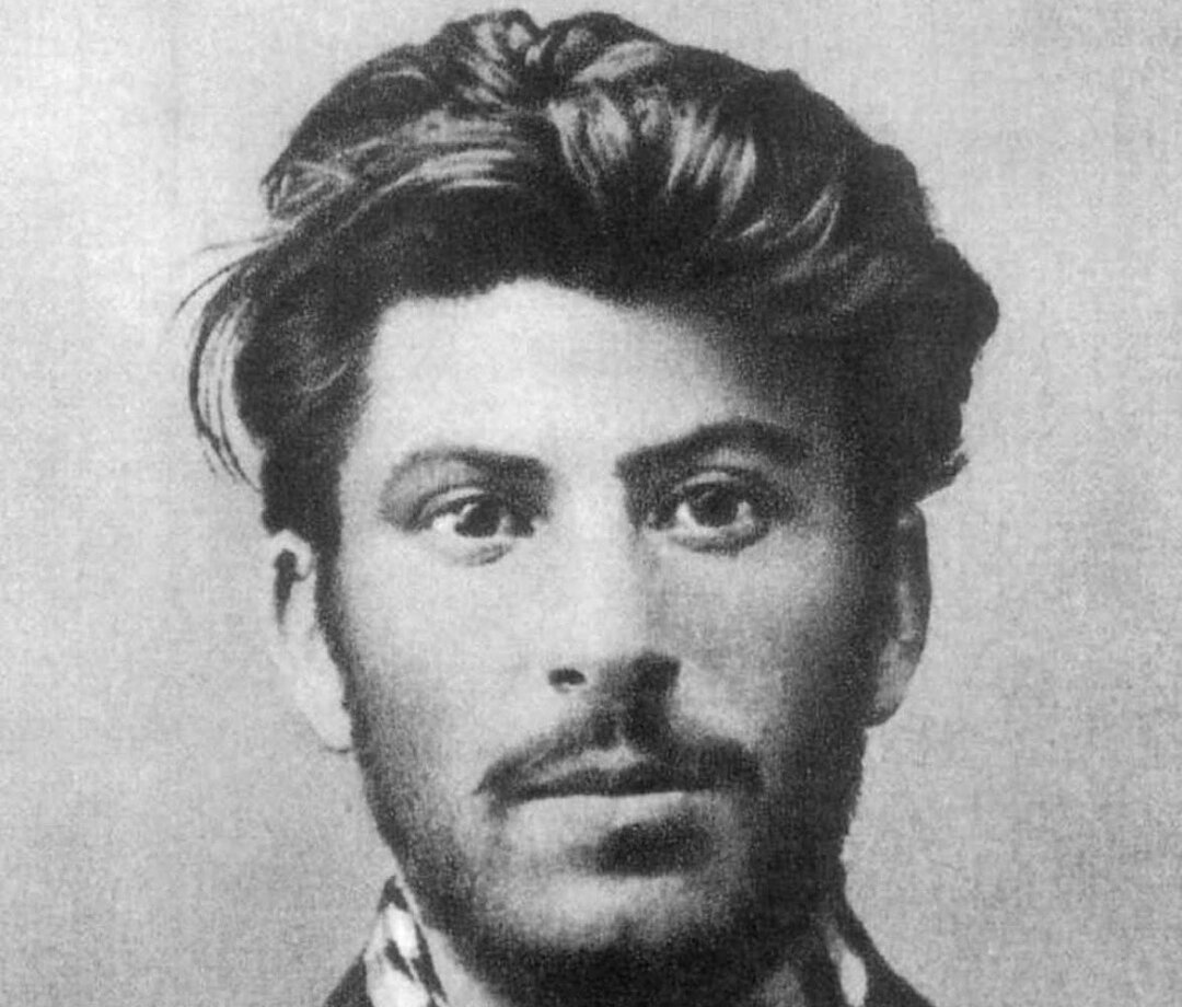 Grayscale Portrait Photo of Joseph Stalin In 1902, wearing a dark suit