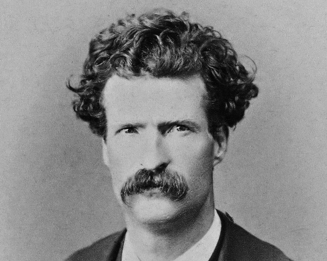 Grayscale Portrait Photo of Mark Twain in a dark suit