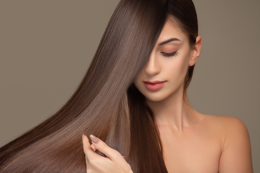 Fashionable brunette woman with straight long shiny hair