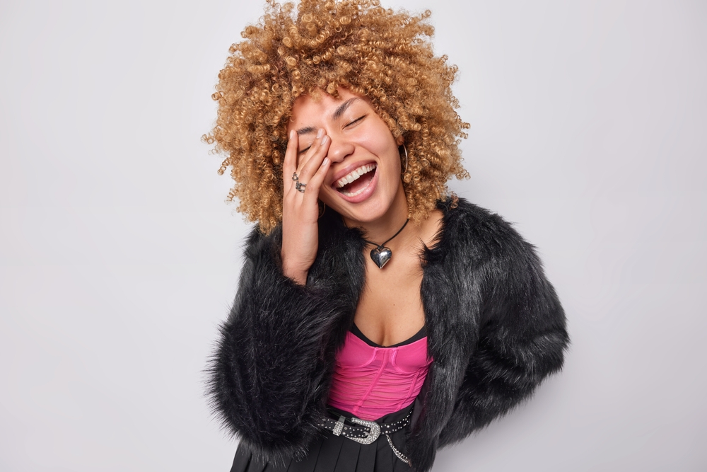 Joyful woman with curly hair