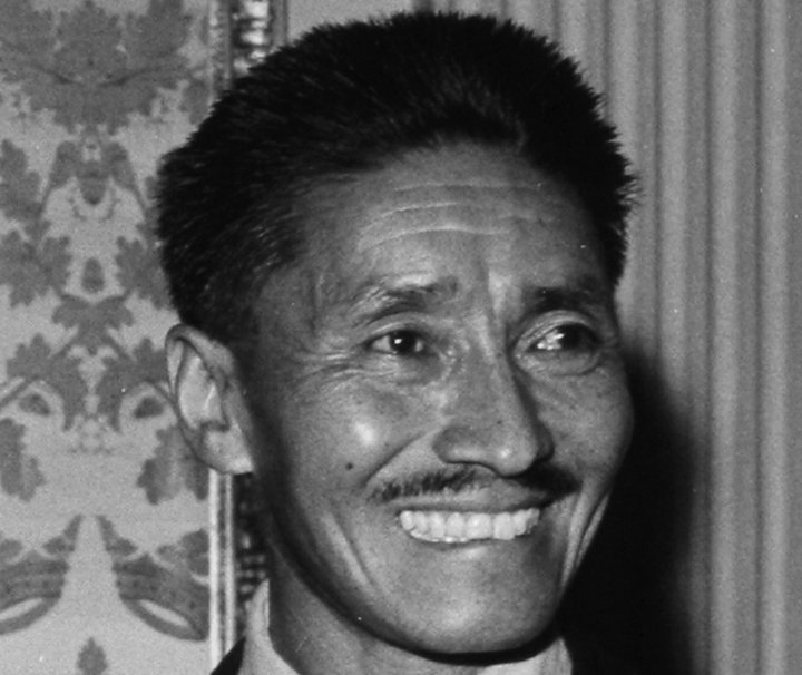 Grayscale Portrait Photo of Sherpa Tenzing Norgay in a dark outfit