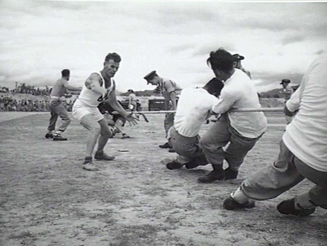 Tug Of War Team Being Coached By Lieutenant Ness At A Sports Carnival