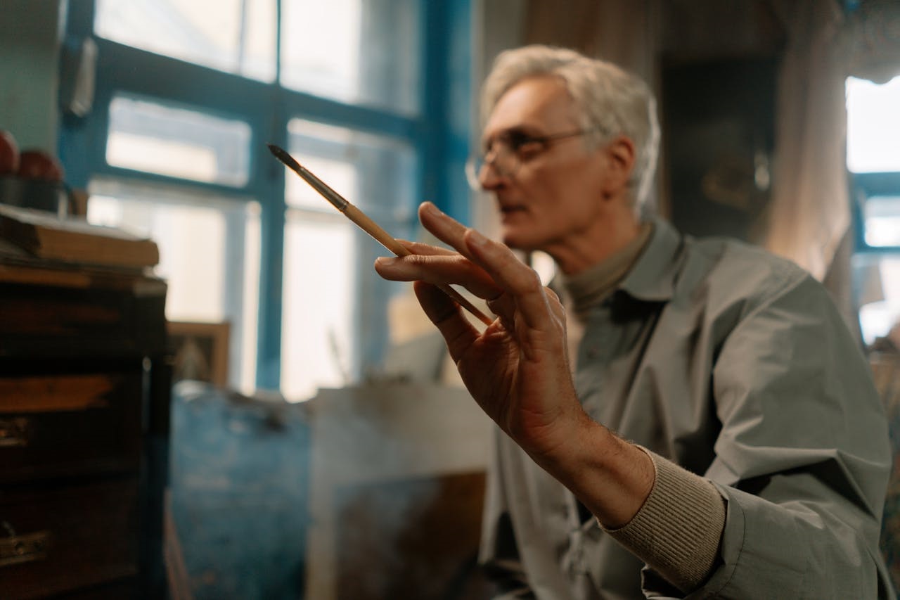 Elderly Man Holding A Paintbrush