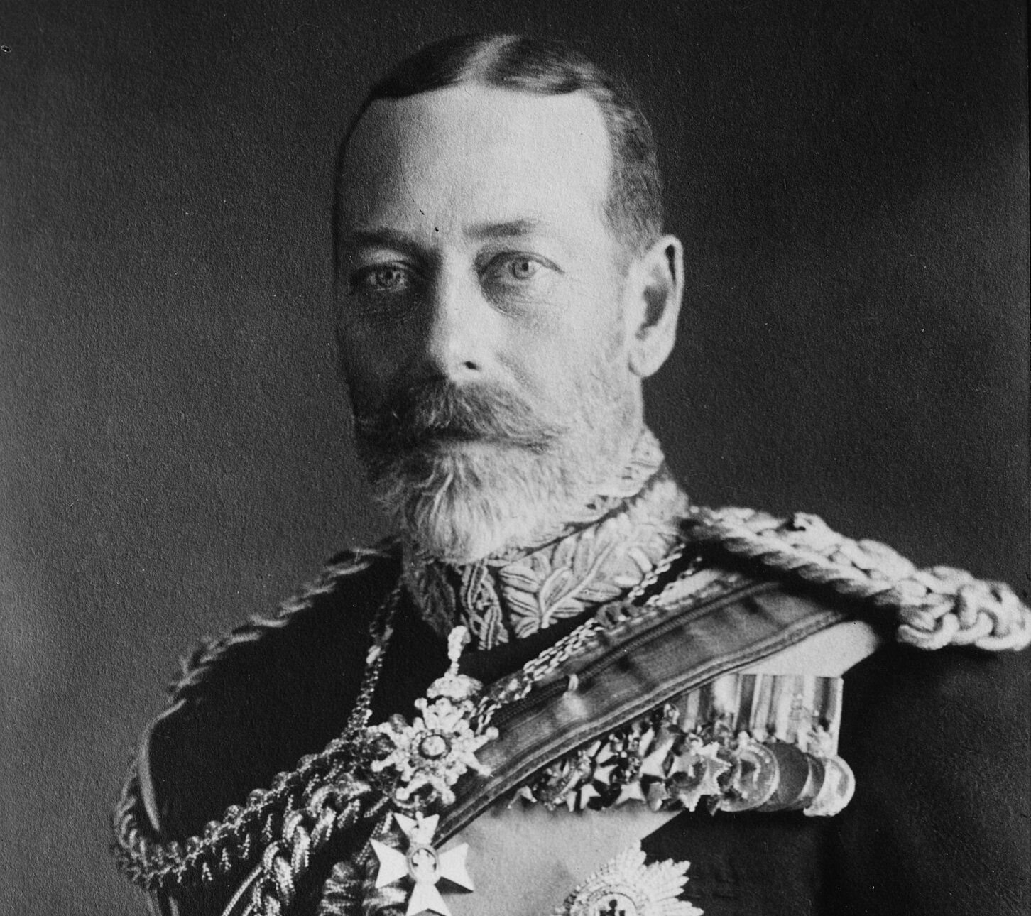 Grayscale Portrait Photo of George V on Dark Background.