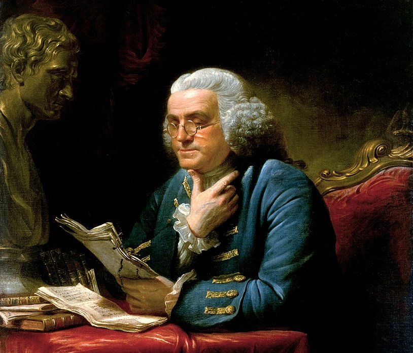 Portrait Painting of Benjamin Franklin in blue outfit and glasses reading