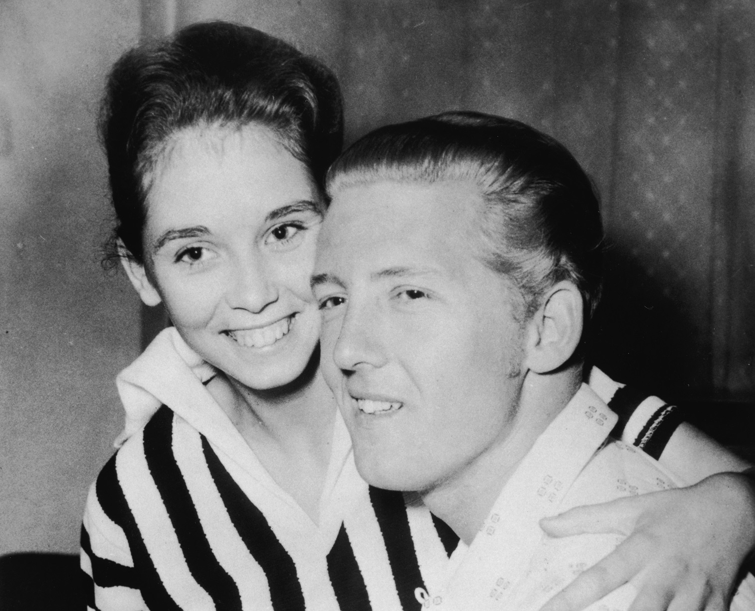 Jerry Lee Lewis holds his second cousin and third wife Myra Brown in his lap at a press conference - 1958.