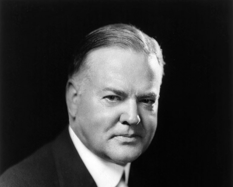 Grayscale Portrait Photo of U.S. President Herbert Hoover in a dark suit