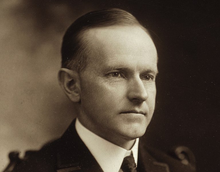 Grayscale Portrait Photo of U.S. President Calvin Coolidge in a dark suit