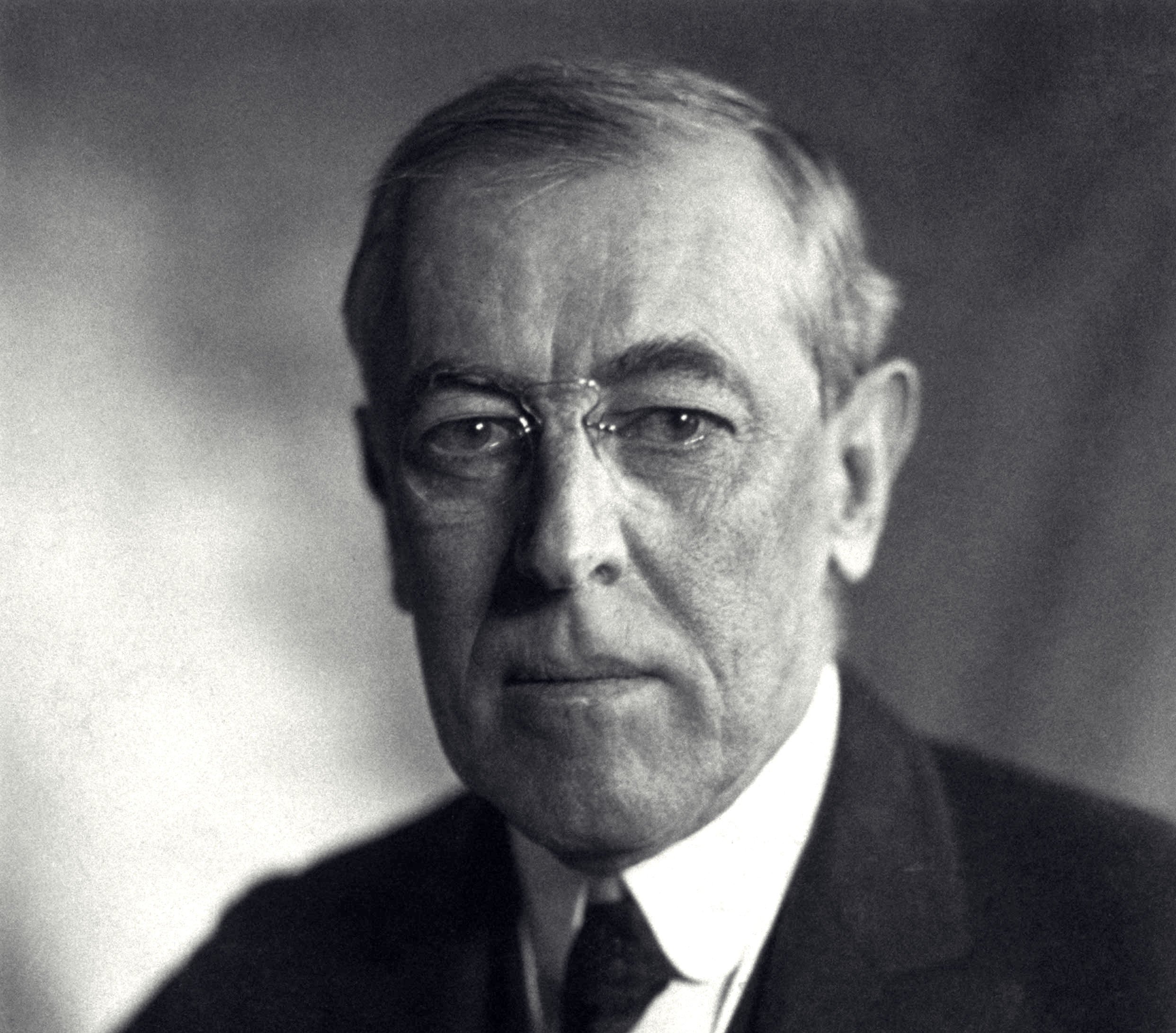 Grayscale Portrait Photo of U.S. President Thomas Woodrow Wilson in a dark suit