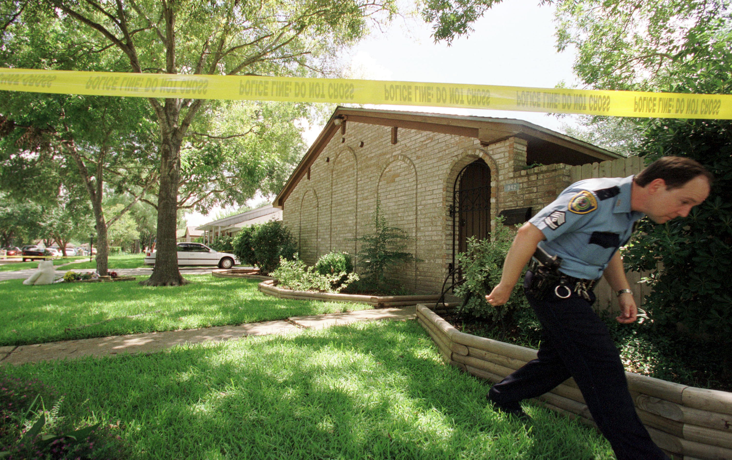 A Houston police officer exits June 21, 2001 the home where Andrea Yates, 36, allegedly killed her five children by drowning them - 2001