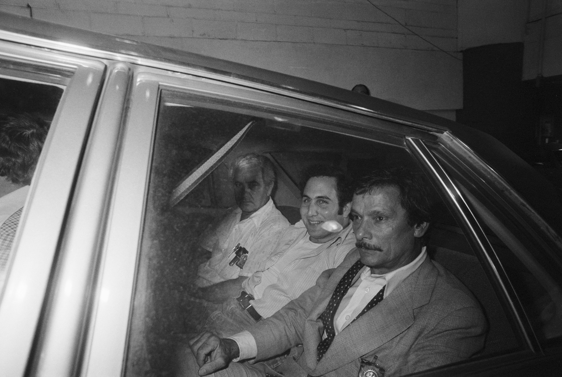 David Berkowitz, 24, (c) sits in police car - 1977