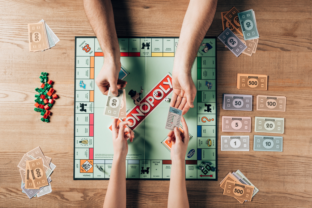 Cropped view of man and woman playing monopoly