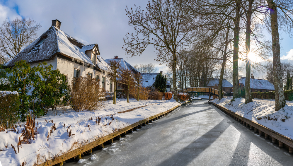Giethoorn village in winter, frozen canal