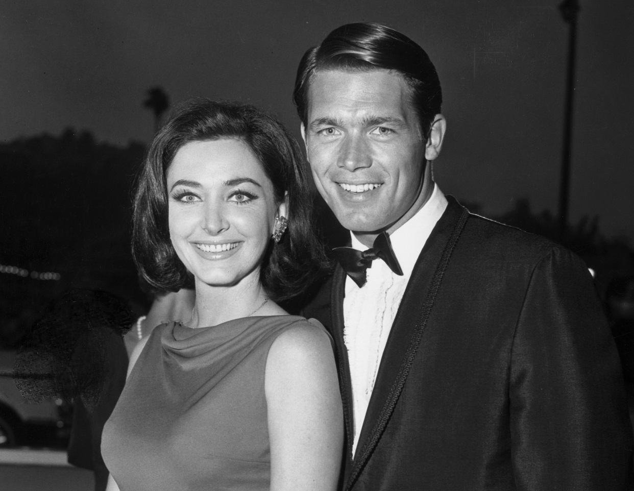 American actors Shelby Grant and Chad Everett pose in formal attire - 1965